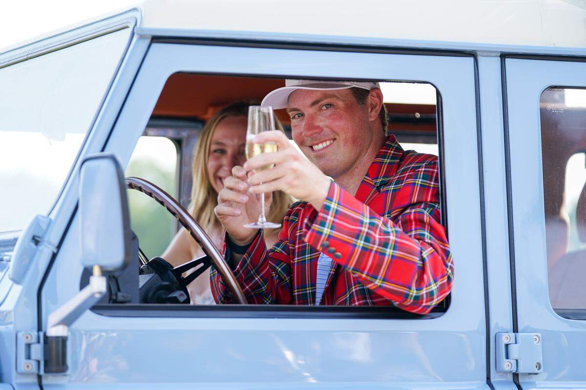 Ben Griffin, with his fiancee Dana Myeroff sit in tournament winner’s 1992 Schwab Defender after the Charles Schwab Challenge golf tournament. 