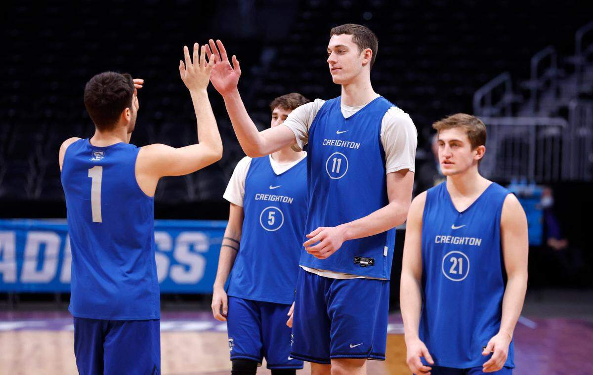 Creighton’s Ryan Kalkbrenner (11) high-fives Ben Shtolzberg (1) during Creighton’s practice at Ball Arena in Denver, Colo. Thursday, March 16, 2023. N.C. State will face Creighton in the first round of the NCAA Tournament Friday.