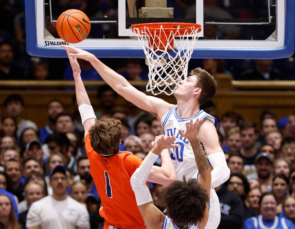 Duke’s Kyle Filipowski (30) blocks the shot by Bucknell’s Ian Motta (1) during the first half of Duke’s game against Bucknell at Cameron Indoor Stadium in Durham, N.C., Friday, Nov. 17, 2023.