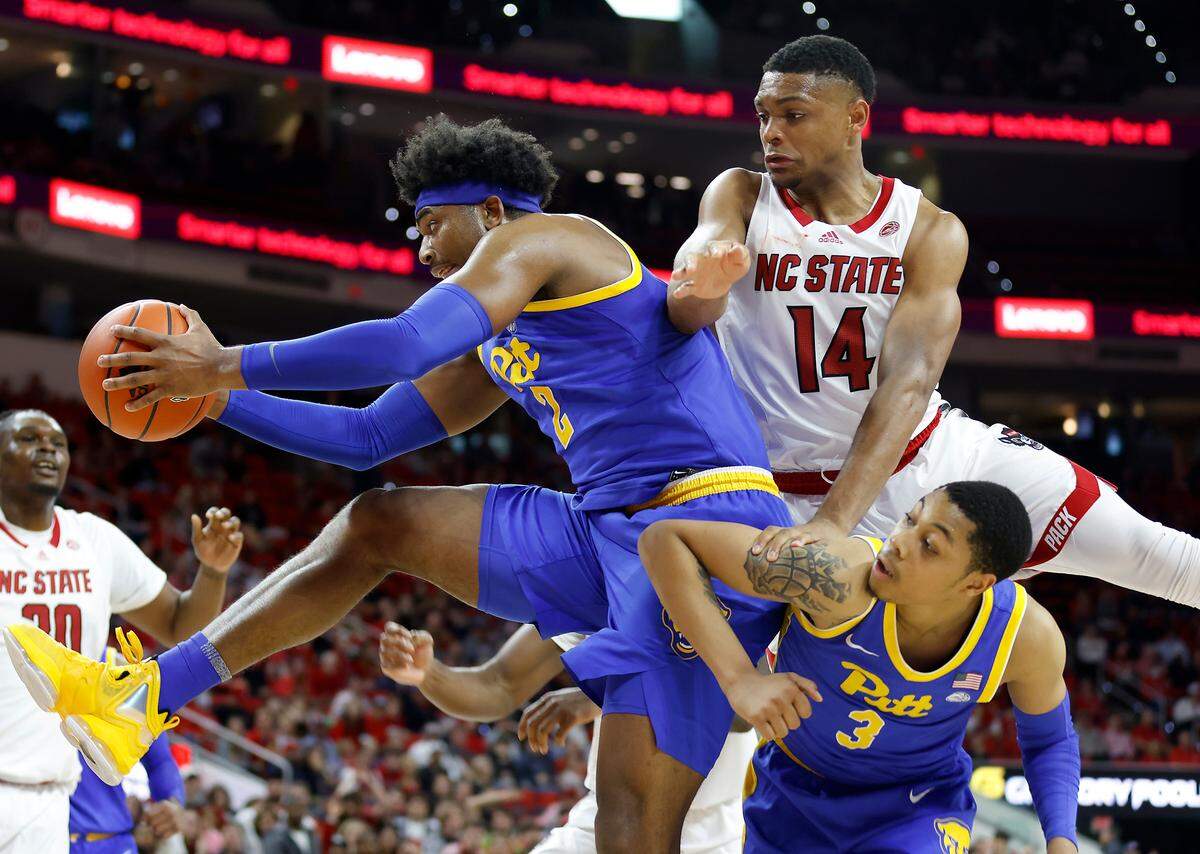 Pitt’s Blake Hinson grabs the ball away from N.C. State’s Casey Morsell during the second half of a men’s basketball game at PNC Arena on Friday, Dec. 2, 2022, in Raleigh, N.C.