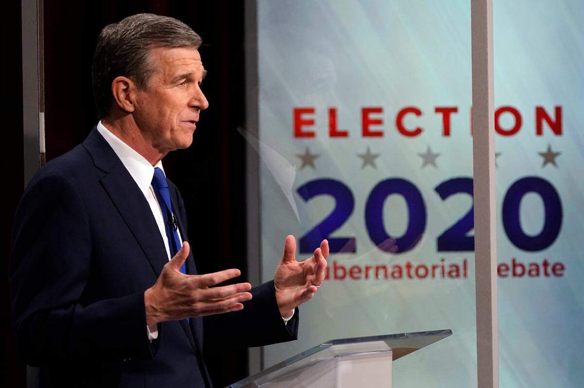 North Carolina Gov. Roy Cooper makes a comment during a live televised debate with Lt. Gov. Dan Forest at UNC-TV studios in Research Triangle Park, N.C., Wednesday, Oct. 14, 2020.