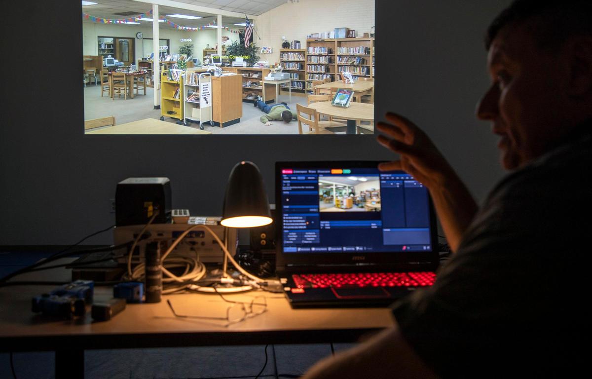 Travis Baker, a Wake Tech law enforcement instructor, explains how the new, portable FATS 100P Meggitt Training Simulator will help train local law enforcement agencies across the state on active shooter situations, focusing on verbal de-escalation skills, on Monday, Sept. 9, 2019, at Wake Technical Community College in Raleigh, NC.