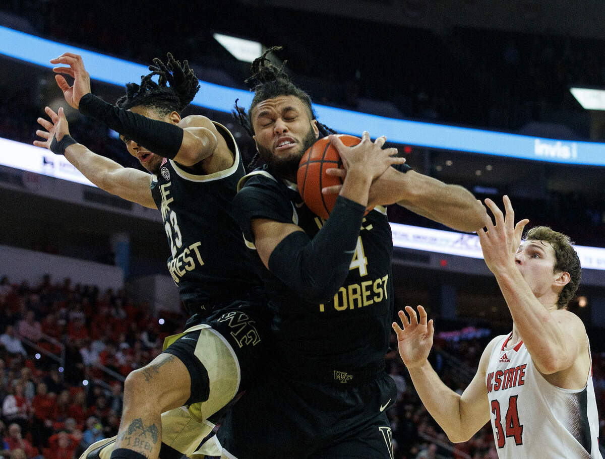 Wake Forest’s Efton Reid III (4) pulls down a rebound away from N.C. State’s Ben Middlebrooks during the second half of the Wolfpack’s 83-76 win at PNC Arena on Tuesday, Jan. 16, 2024, in Raleigh, N.C.