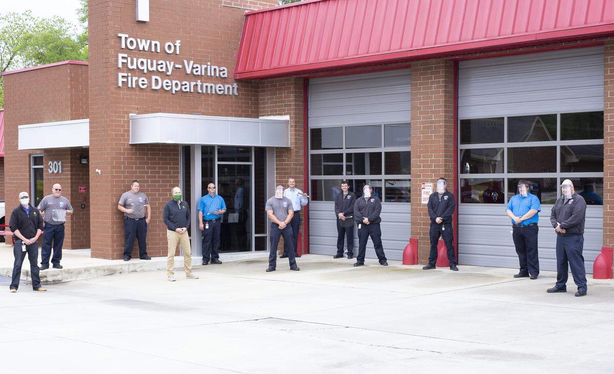 The Fuquay Varina Fire Department poses with face shields provided by John Deere. The company donated 100 shields to the fire and police departments.