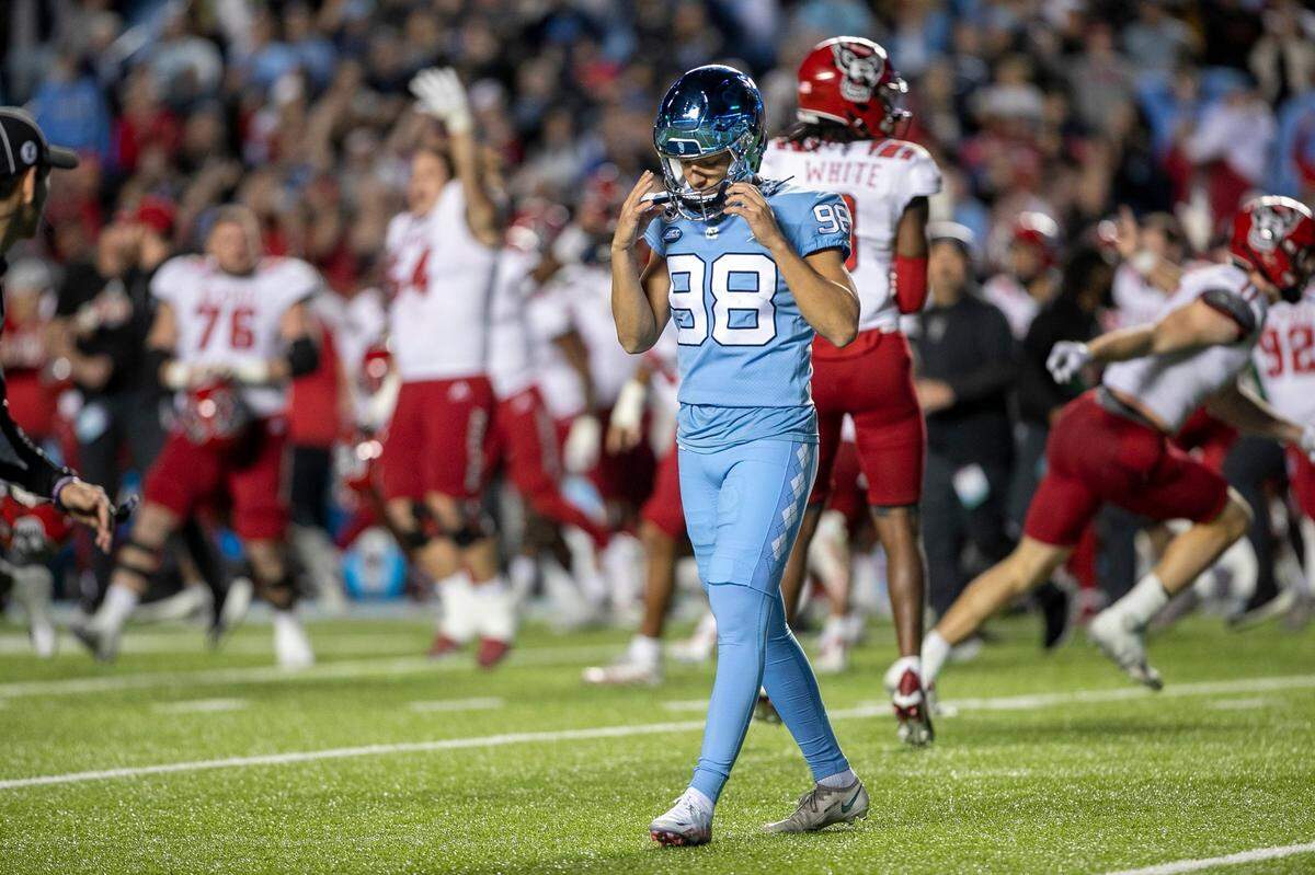 North Carolina kicker Noah Burnette (98) reacts after missing a 35-yard field goal attempt in overtime to give N.C. State a 30-27 victory on Friday, November 25, 2022 at Kenan Stadium in Chapel Hill, N.C.