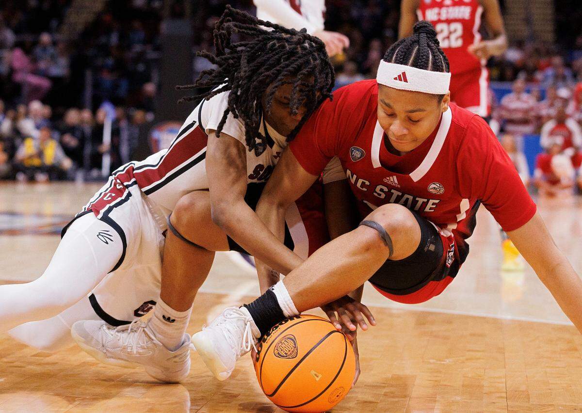 N.C. State’s Zoe Brooks and South Carolina’s MiLaysia Fulwiley scramble for a loose ball during the first half of the Wolfpack’s Final Four matchup at Rocket Mortgage FieldHouse on Friday, April 5, 2024, in Cleveland, Ohio.