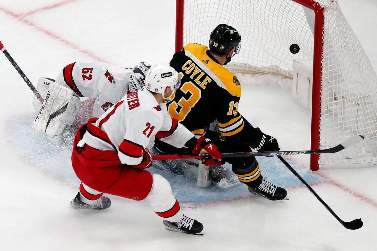 Boston Bruins’ Charlie Coyle (13) scores against Carolina Hurricanes’ Pyotr Kochetkov (52) during the first period of Game 3 of an NHL hockey Stanley Cup first-round playoff series, Friday, May 6, 2022, in Boston. (AP Photo/Michael Dwyer)