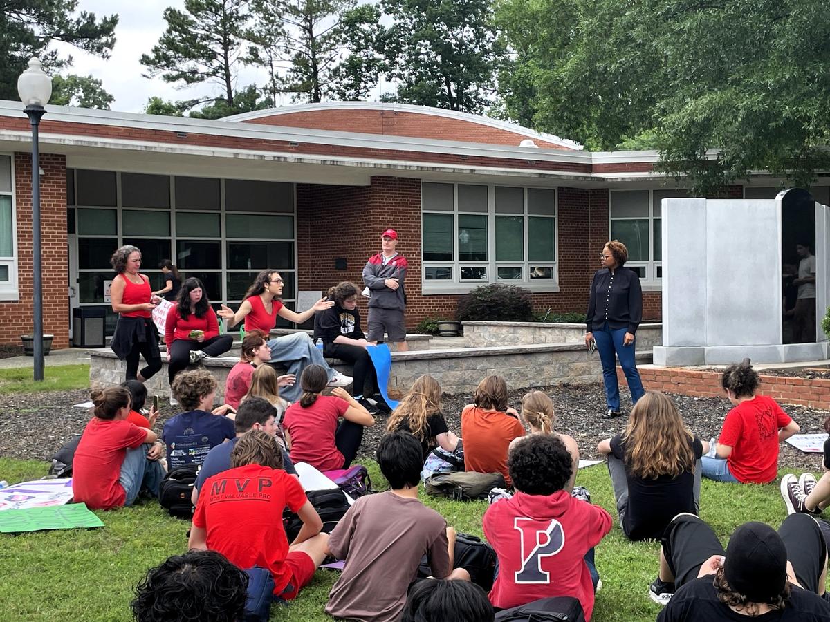 Chapel Hill-Carrboro City Schools Superintendent Nyah Hamlett listens as Carrboro High School junior Oak Avary challenges her response to the students’ grievances during a walkout protest Thursday, May 29, 2025.