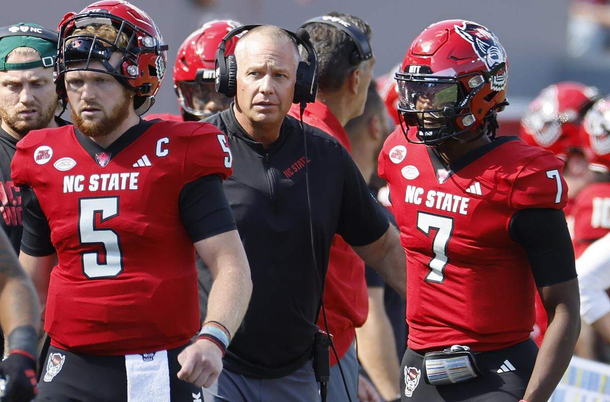 N.C. State head coach Dave Doeren talks with quarterback MJ Morris (7) after he threw an interception during the first half of N.C. State’s game against Marshall at Carter-Finley Stadium in Raleigh, N.C., Saturday, Oct. 7, 2023.
