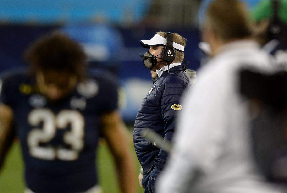 Notre Dame head coach Brian Kelly, center, stands along the teamÕs sideline during the ACC Championship game. Clemson defeated Notre Dame 34-10 to win the championship at Bank of America Stadium in Charlotte, NC on Saturday, December 19, 2020.  