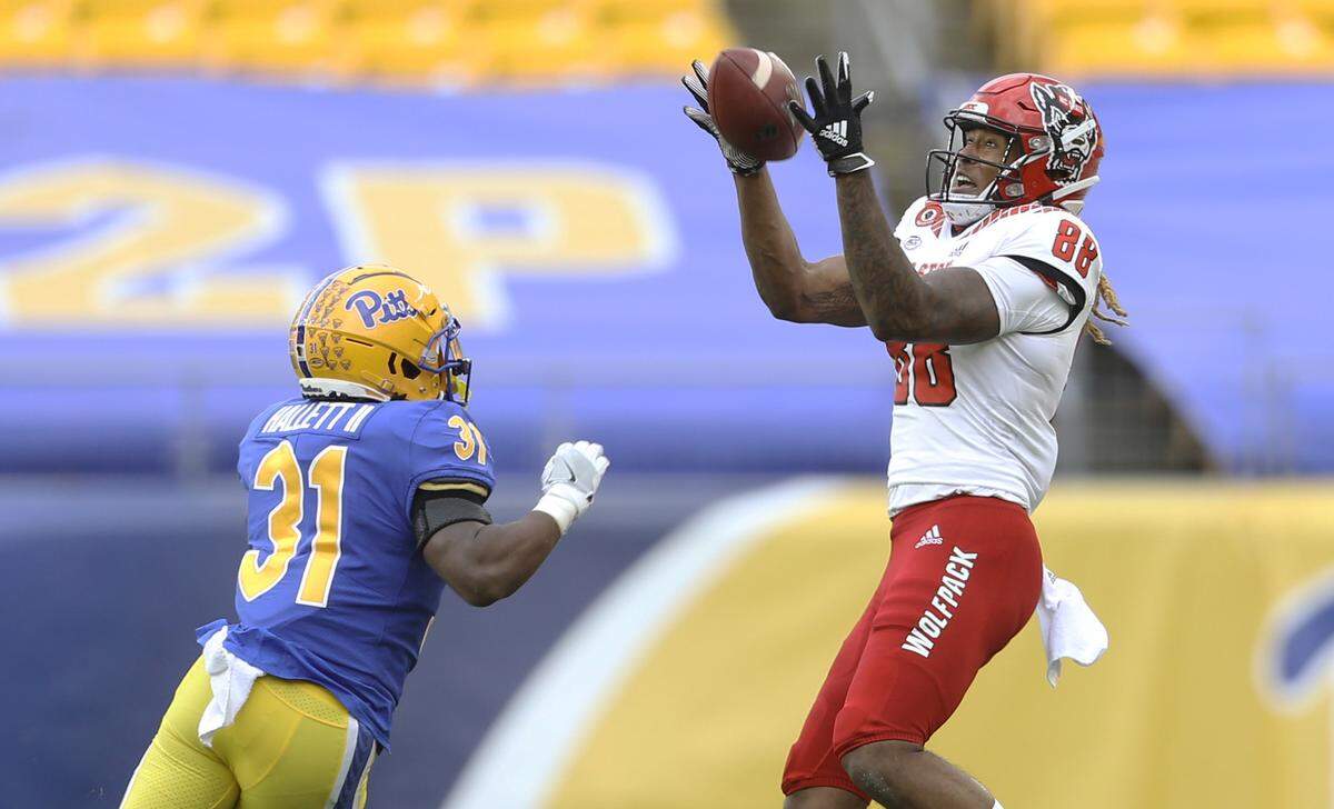 N.C. State’s Devin Carter (88) makes a catch as Pittsburgh Panthers defensive back Erick Hallett (31) tries to defend during the Wolfpack’s game against the Panthers at Heinz Field in Pittsburgh, PA, Saturday, Oct. 3, 2020.