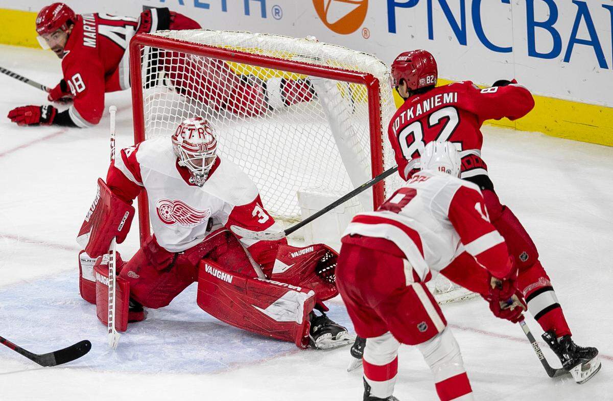 Detroit goalie Alex Nedeljkovic (39) stops a scoring attempt by Carolina’s Hurricanes’ Jesperi Kotkaniemi (82) during the second period on Tuesday, April 11, 2023 at PNC Arena in Raleigh, N.C.