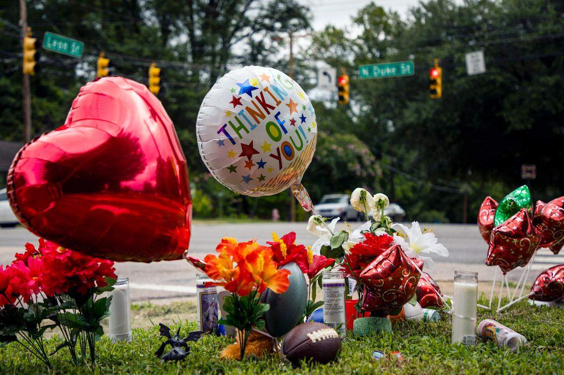 Balloons wave across a busy N. Duke St. intersection to Leon St., where 9-year-old Z’Yon Person was fatally shot while riding with his aunt to get snow cones Sunday evening, on Wednesday, Aug. 21, 2019, in Durham, NC.