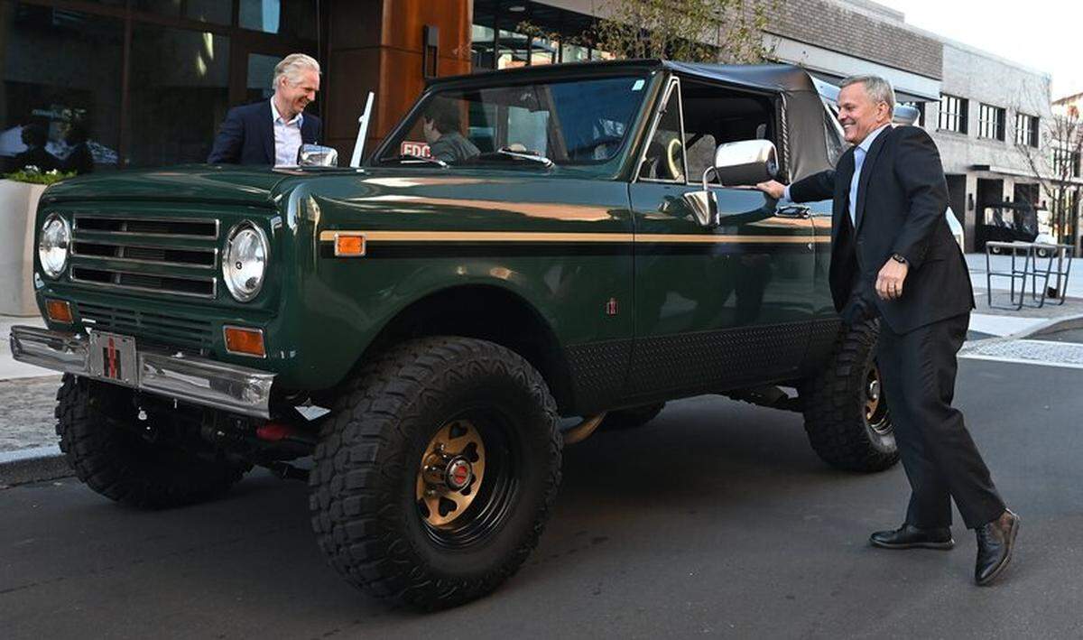 North Carolina Gov. Josh Stein, right, closes the door on a Scout Motors vehicle after driving up to a press conference where it was announced that the company is making Charlotte its new corporate headquarters on November 12, 2025. 