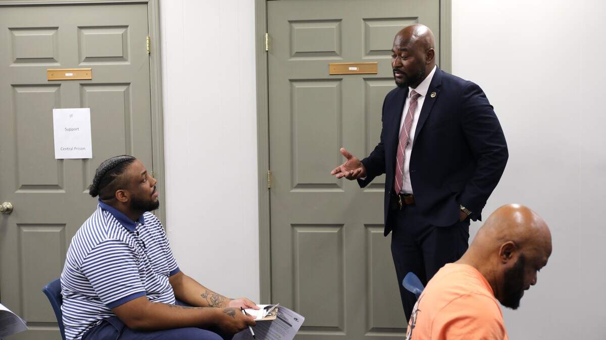 Central Prison Warden Jamel James, right, speaks with job applicant Jerome Yow, left, about the North Carolina Department of Adult Correction, on Thursday, June 4, 2026, at Central Prison.