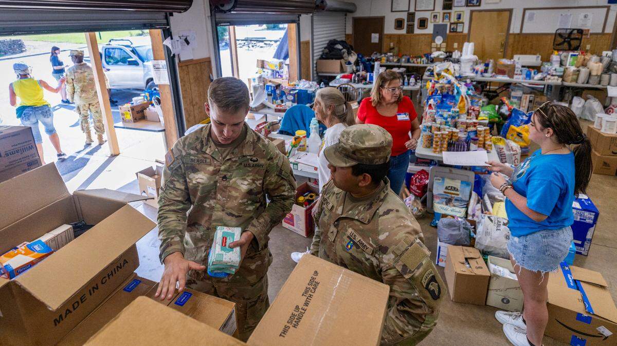 Soldiers with the 101st Airborne Division Air Assault, 2nd Brigade Combat Team, from Fort Campbell, Kentucky, help volunteers distribute water, food, toiletries, and other aid to residents in Maggie Valley on Tuesday, October. 8, 2024. The team has been using the Maggie Valley Pavilion and Town Hall as a distribution base for relief efforts in the town following Tropical Storm Helene.