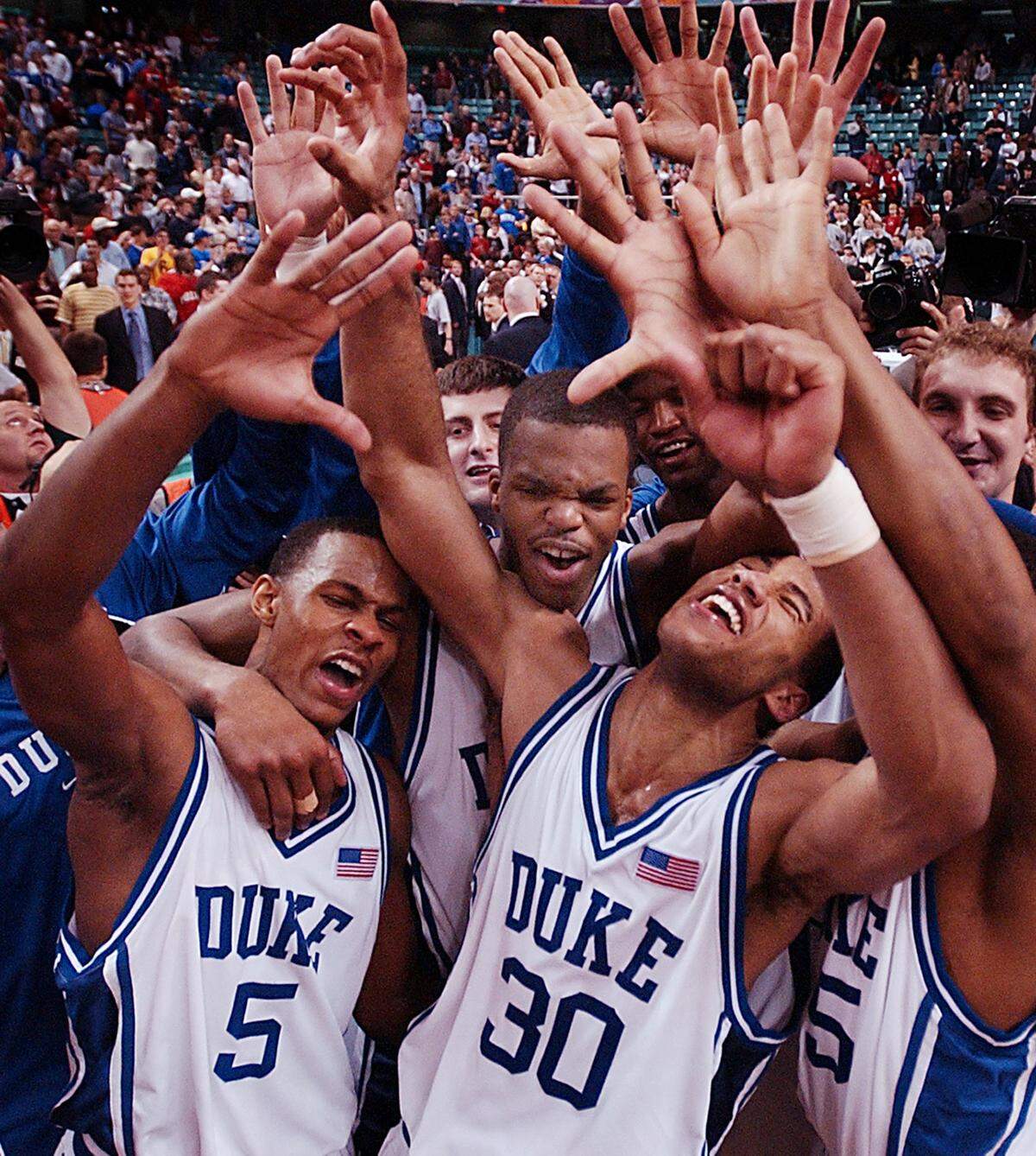 Duke's Daniel Ewing, Shelden Williams and Dahntay Jones celebrate as the Blue Devils secured a record-setting fifth-straight ACC Title with a 84-77 win over N.C. State in the ACC Championship in Greensboro.