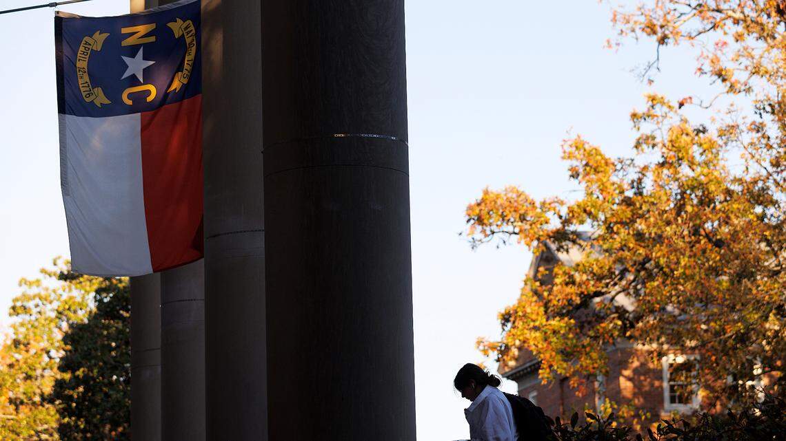 A North Carolina flag flies above South Building on the campus of UNC-Chapel Hill on Monday, Oct. 30, 2023.