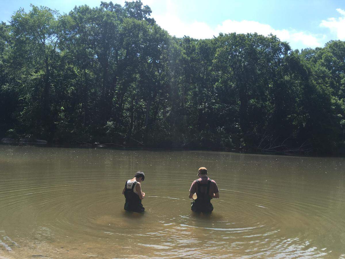 Duke researchers Amy Yoon and George Tait collect water samples for evidence of toxic forever chemicals in North Carolina’s Haw River in July 2019. The Haw rated just beind South Carolina’s Pocotaligo River for overall forever chemical concentrations that an environmental group documented in 2024.