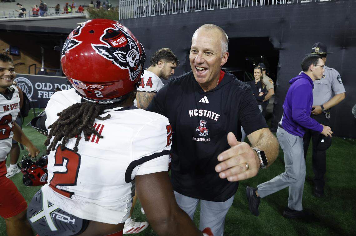 N.C. State head coach Dave Doeren hugs Ronnie Royal III (2) after N.C. State’s 34-24 victory over Wake Forest at Allegacy Stadium in Winston-Salem, N.C., Thursday, Sept. 11, 2025.