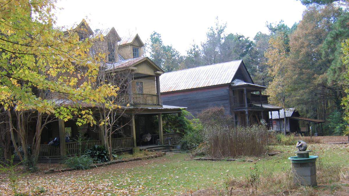 What’s left of the small village of Merry Oaks is for sale in North Carolina. Pictured is the Merry Oaks hotel on the left, the Yates Thomas General Store in the middle and the Merry Oaks Train Depot on the far right.