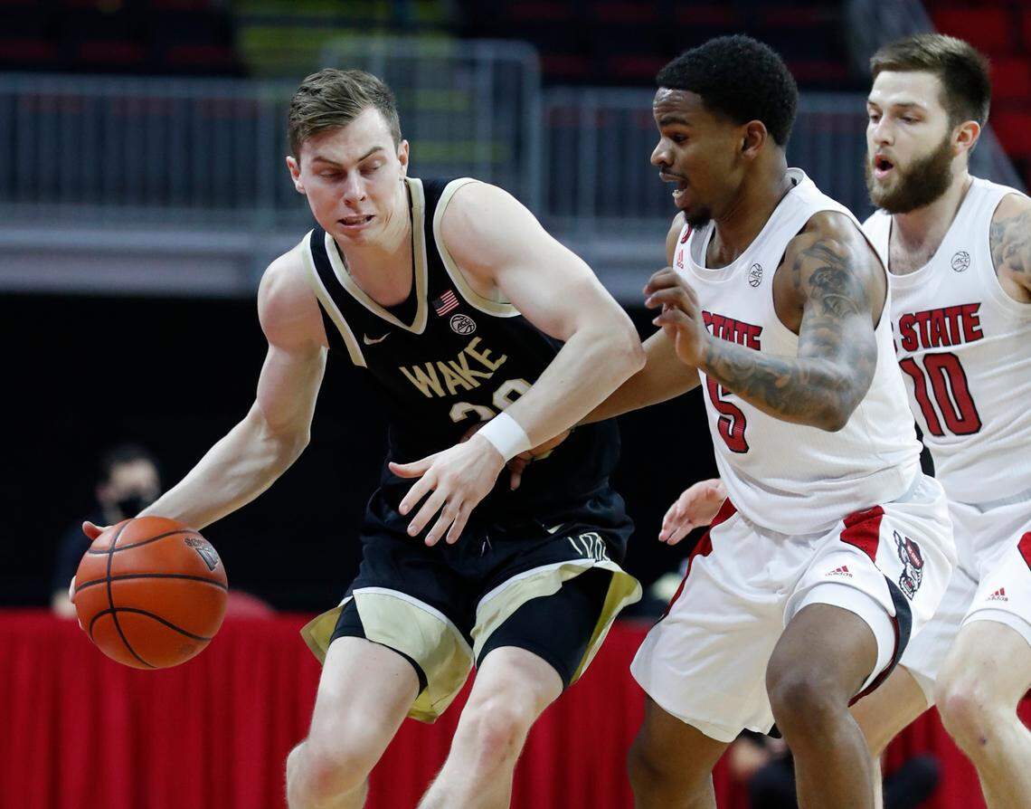 Wake Forest’s Jonah Antonio (20) tries to get around N.C. State’s Thomas Allen (5) during the first half of N.C. State’s game against Wake Forest at PNC Arena in Raleigh, N.C., Wednesday, January 27, 2021.