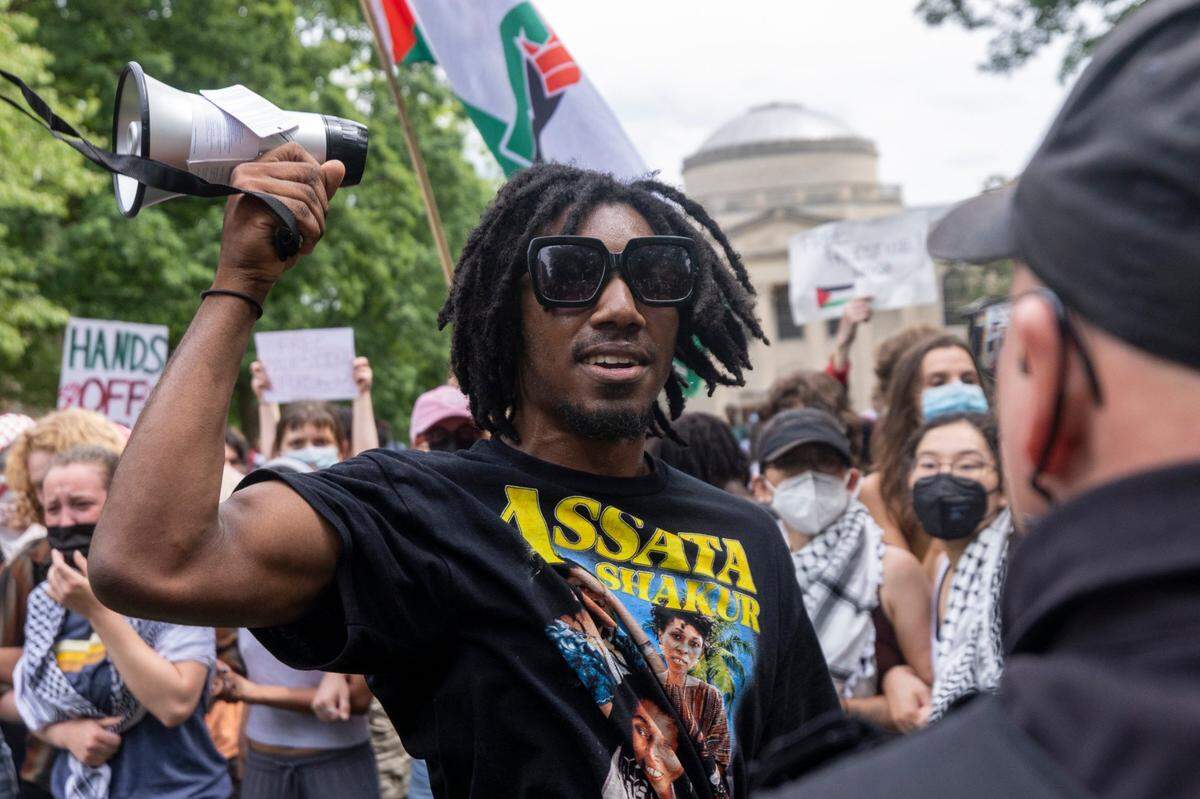 Pro-Palestinian demonstrators clash with police after replacing an American flag with a Palestinian flag Tuesday, April 30, 2024 at UNC-Chapel Hill. Police removed a “Gaza solidarity encampment” earlier Tuesday morning.