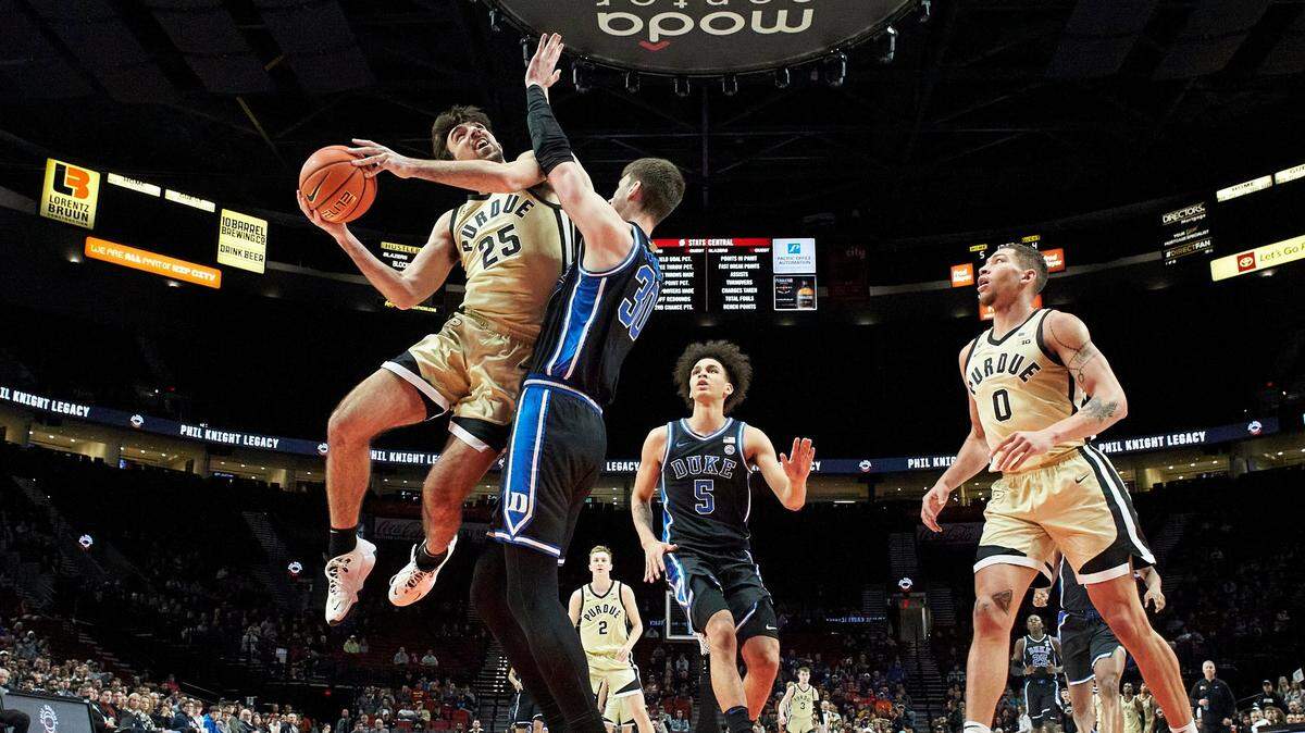 Purdue guard Ethan Morton (25) shoots over Duke center Kyle Filipowski during the first half of an NCAA college basketball game in the Phil Knight Legacy Championship in Portland, Ore., Sunday, Nov. 27, 2022. (AP Photo/Craig Mitchelldyer)