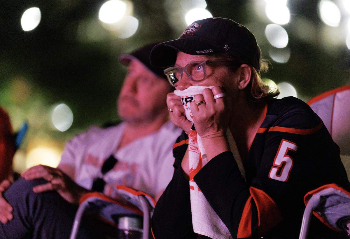 Carolina Hurricanes fans react while watching the second period during a watch party for Game 2 of the Stanley Cup Final against the Vegas Golden Knights in Moore Square on Thursday, June 4, 2026, in Raleigh, N.C.