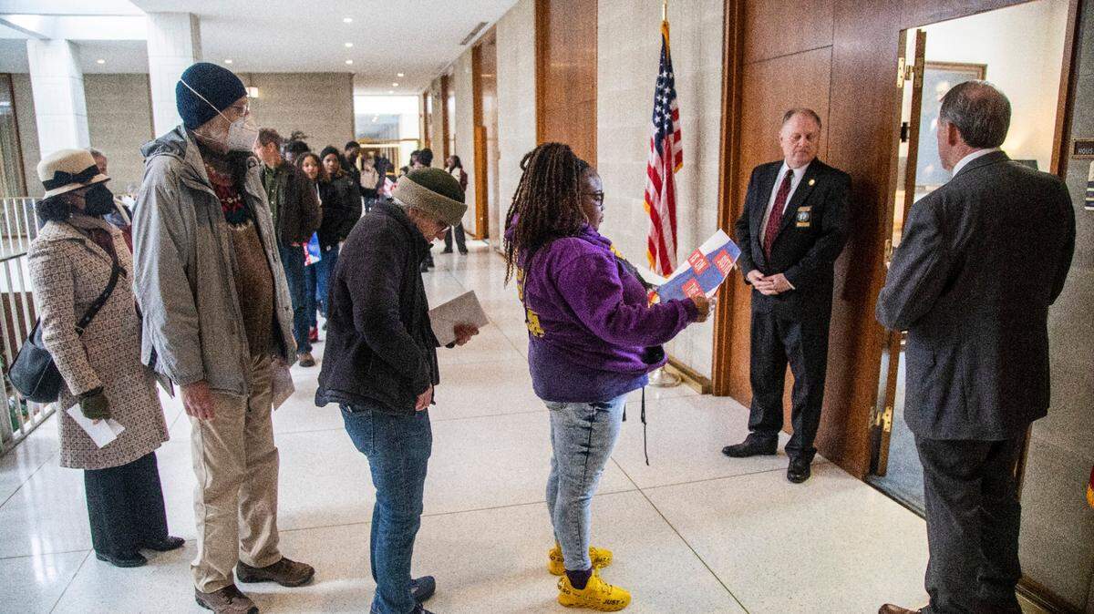 Voting rights activists wait in line to deliver letters outside House Speaker Tim Moore’s office at the NC Legislative Building Tuesday, March 14, 2022 as as the NC Supreme Court revisited the question of whether partisan gerrymandering is forbidden under the state constitution.