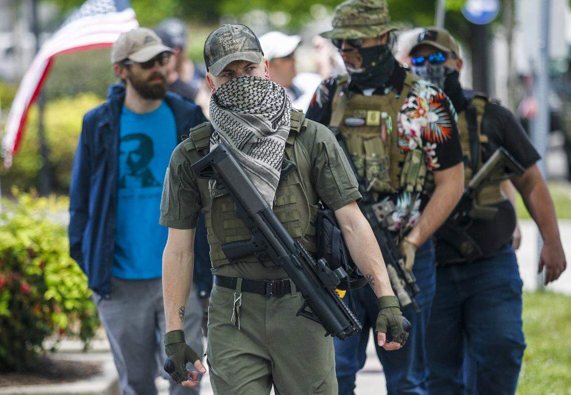 A group of about fourteen mostly-armed demonstrators march around downtown Raleigh touting the 2nd Amendment Friday, May 1, 2020.