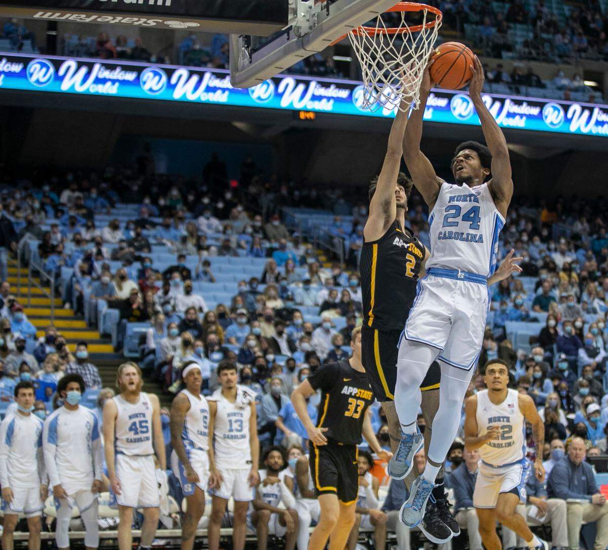North Carolina’s Kerwin Walton (24) drives to the basket against Appalachian State’s Christopher Mantis (2) during the second half on Tuesday, December 21, 2021 at the Smith Center in Chapel Hill, N.C.