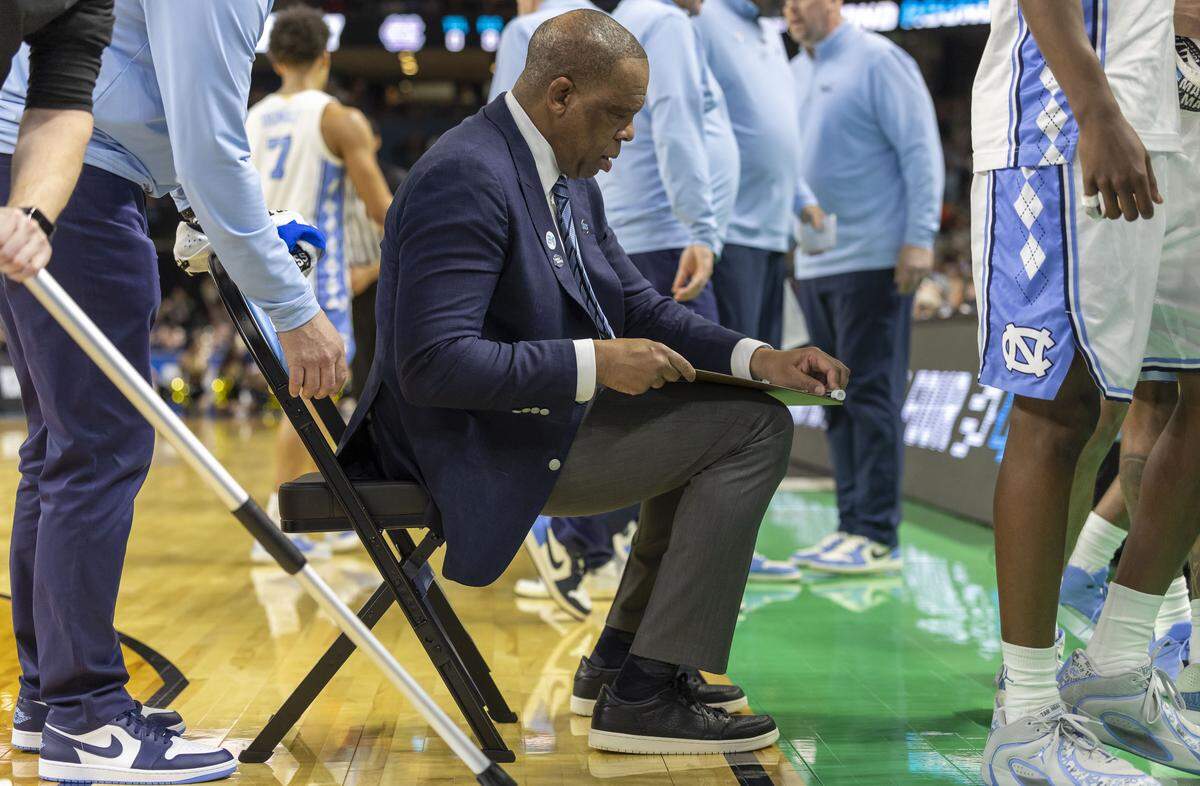 North Carolina coach Hubert Davis cleans his white board after diagraming plays during the final timeout in overtime against VCU on Thursday, March 18, 2026, during the first round of the NCAA Tournament at Bon Secours Arena in Greenville, S.C.