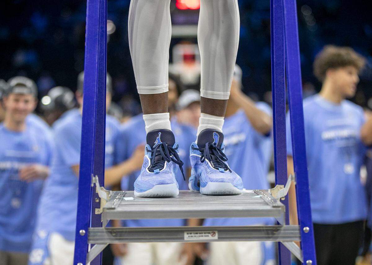 North Carolina’s Dontrez Styles (3) stands atop the ladder to cut down the net following the Tar Heels’ 69-49 victory over Saint Peter’s in the NCAA East Regional Championship game on Sunday, March 27, 2022 at Wells Fargo Center in Philadelphia, Pa.