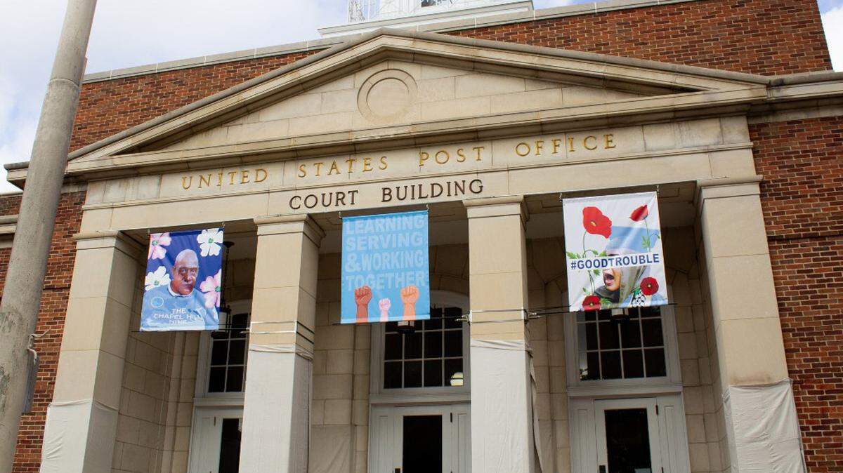 The town of Chapel Hill has taken down a set of artistic banners on display at Peace & Justice Plaza titled “The Power of Good Trouble.”