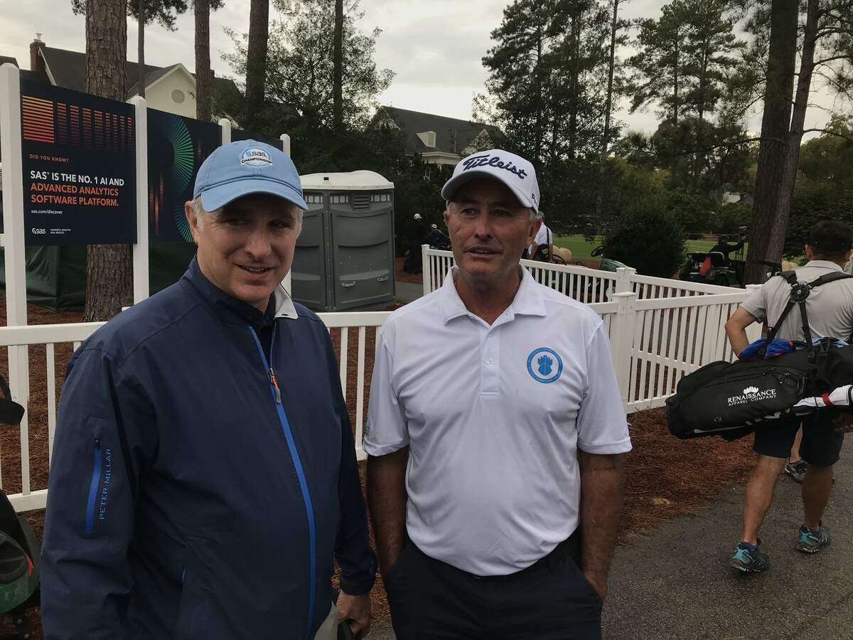 David McKenzie of Australia, right, chats with SAS Championship tournament director Jeff Kleiber near the 18th green as he waits for Jerry Kelly to finish the final round. McKenzie finished second on Oct. 13, 2019.