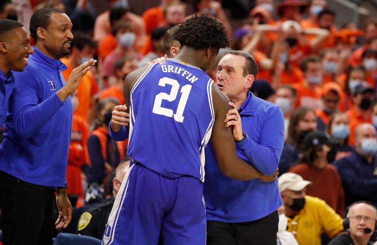 Duke head coach Mike Krzyzewski congratulates A.J. Griffin (21) as he comes off the court in the final seconds of Duke’s 65-61 victory over Virginia at John Paul Jones Arena in Charlottesville, VA, Wednesday, Feb. 23, 2022.