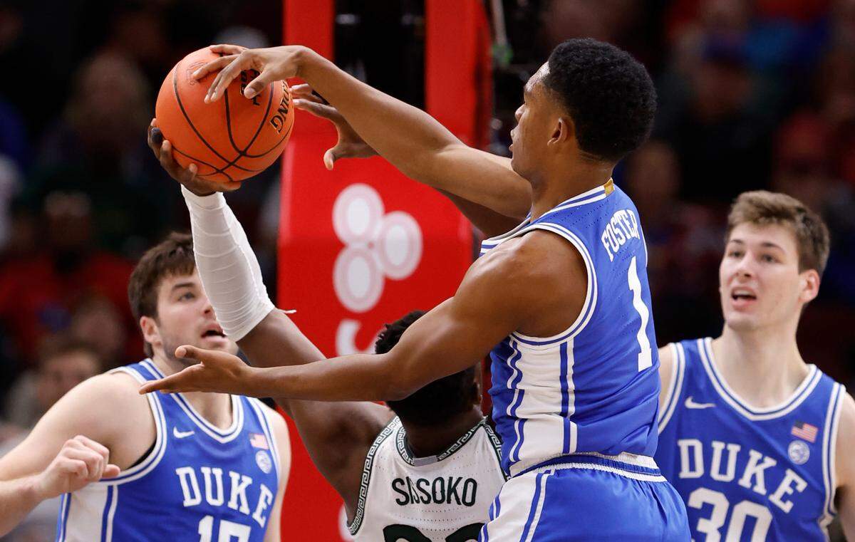 Duke’s Caleb Foster (1) knocks the rebound from Michigan State’s Mady Sissoko (22) during the second half of Duke’s 74-65 victory over Michigan State in the Champions Classic at the United Center in Chicago, IL, Tuesday, Nov. 14, 2023.