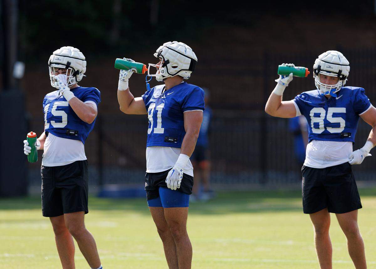 Duke’s Nicky Dalmolin, center, cools off during practice at Brooks Practice Field on Wednesday, July 31, 2024, in Durham, N.C.