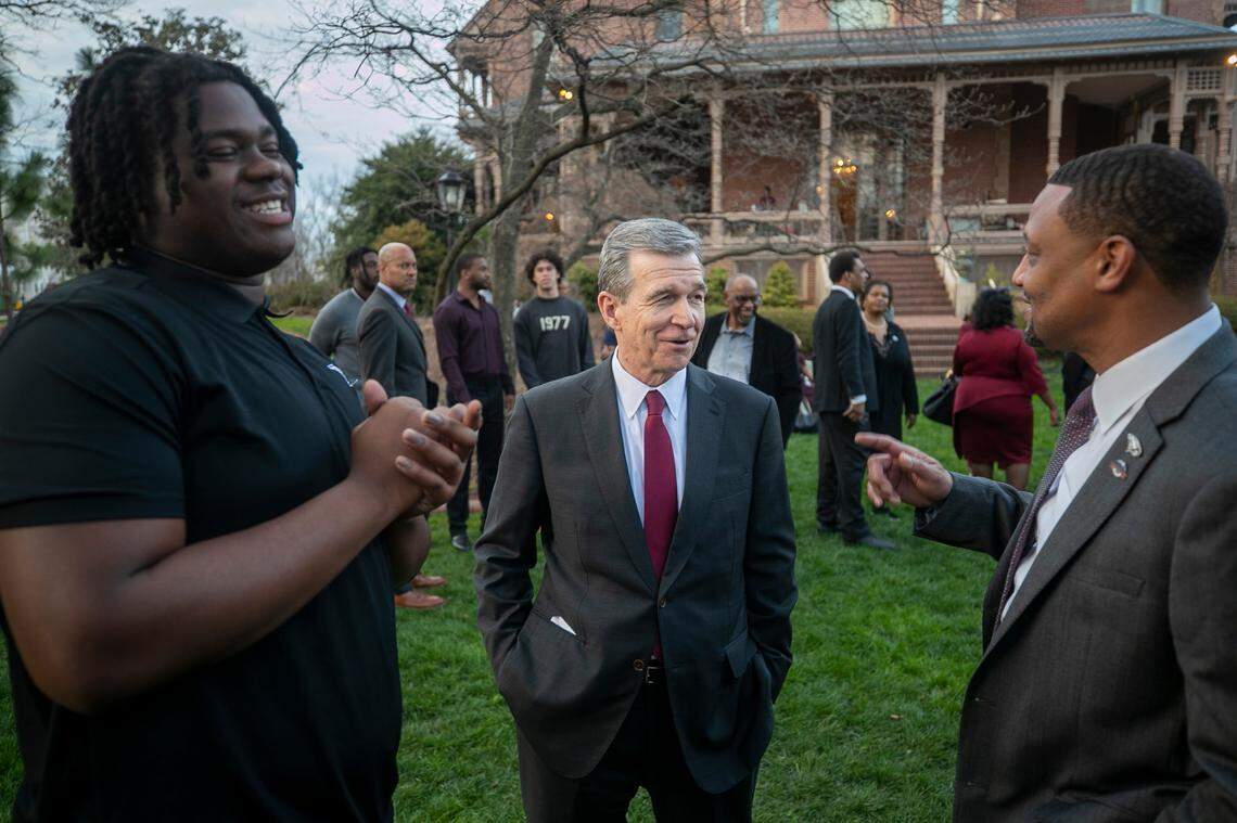 North Carolina Governor Roy Cooper talks with NCCU football coach Trei Oliver, right, during a reception on the lawn of the Executive Mansion, honoring the North Carolina Central University football team’s 2022 HBCU National Championship on Wednesday, February 15, 2023 in Raleigh, N.C.