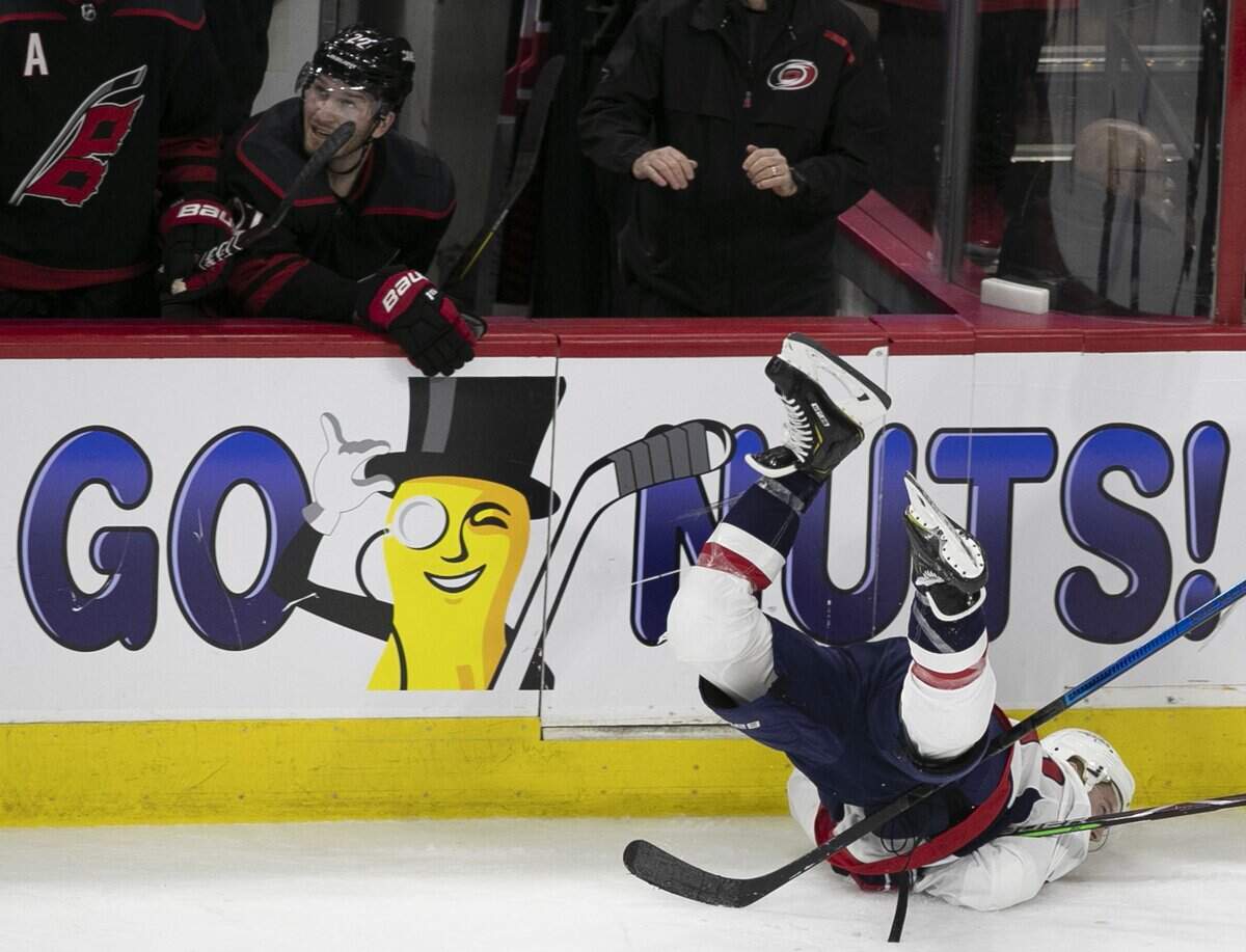 Washington Capital’s Travis Boyd (72) crashes into the board below the Carolina Hurricanes’ bench during the third period in game four of the first round Stanley Cup series game on Thursday, April 18, 2019 at the PNC Arena in Raleigh, N.C.