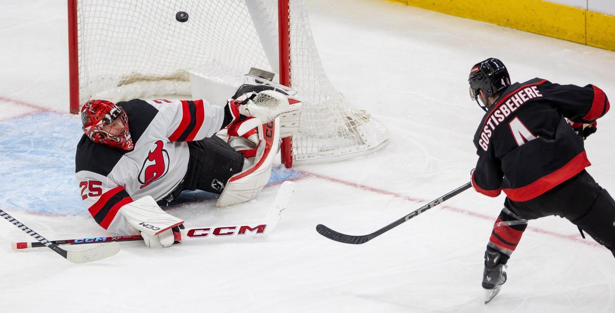 Carolina Hurricanes defenseman Shaye Gostisbehere (04) scores on New Jersey DevilsÕ goalie Jacob Markstrom (25) to tie the score 1-1 in the second period during game two of their Stanley Cup playoff series on Tuesday, April 22, 2025 at Lenovo Center in Raleigh, N.C.