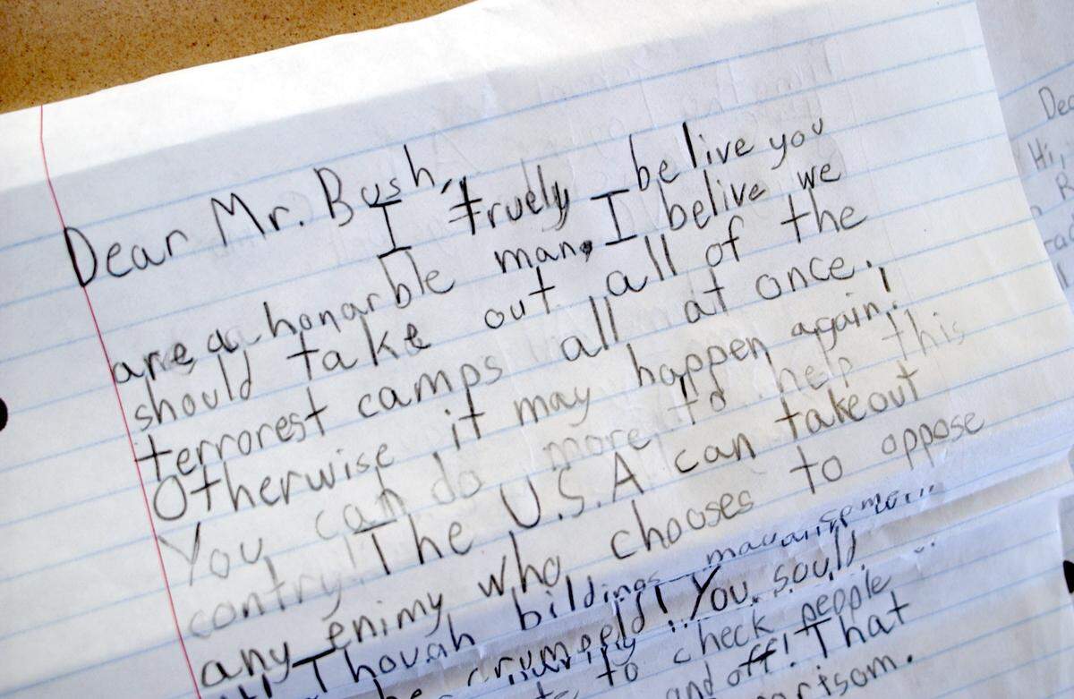 A detail photograph of a letter to President George Bush from a Combs Elementary School Academically Gifted student. Students from Combs are writing the president to express their feelings about the terrorist attacks on the United States. Combs Elementary School is also initiating a fundraising campaign called “Nickels for NY” in which the kids will bring in their spare change, which will be donated to a group selected by the school’s student council.