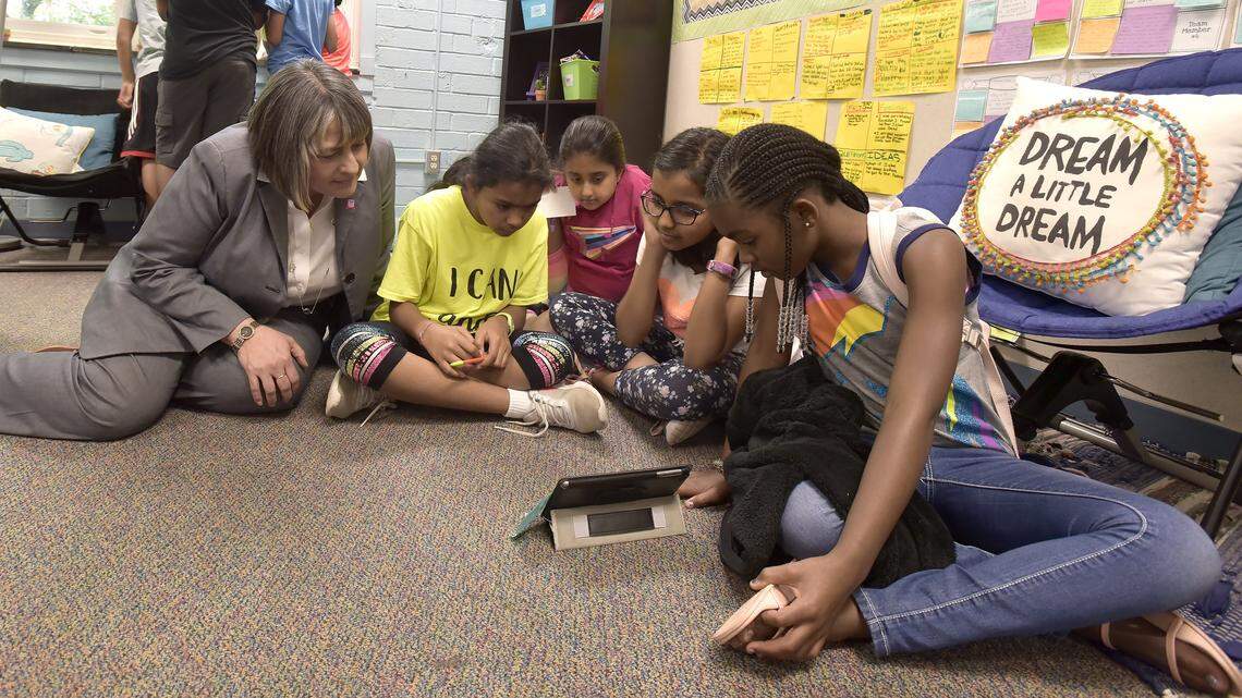 Wake County schools superintendent Catty Moore sits and watches as elementary school students work on a problem at Fuller Elementary School Thursday, May 24, 2018.