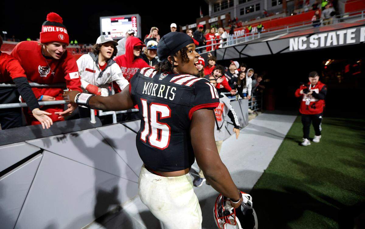 N.C. State quarterback MJ Morris (16) heads to the locker room after N.C. State’s 22-21 victory over Virginia Tech at Carter-Finley Stadium in Raleigh, N.C., Thursday, Oct. 27, 2022.