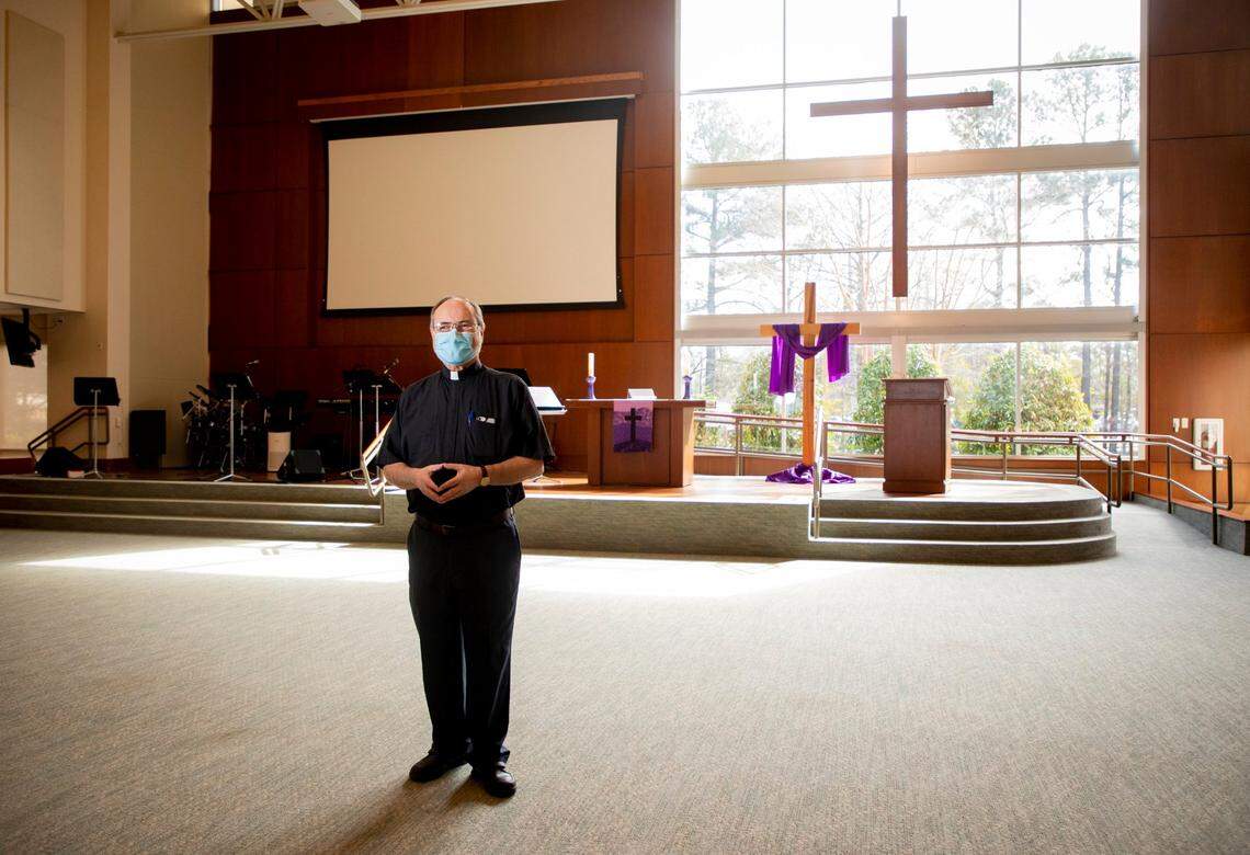 Pastor Wolfgang Herz-Lane, the lead pastor of Christ the King Lutheran, stands for a portrait in the contemporary service sanctuary, on Thursday, Feb. 25, 2021, in Cary, N.C.