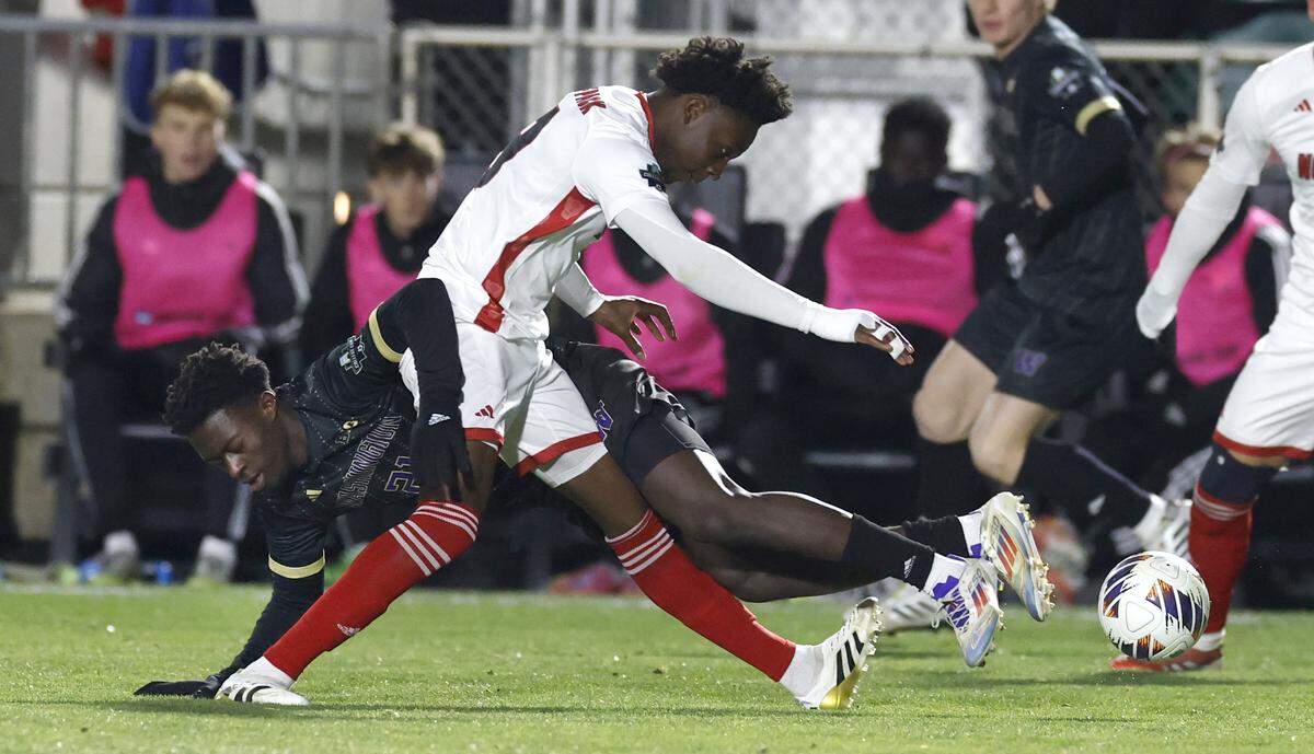 N.C. State's Ibrahim Conde (9) battles Washington's Osato Enabulele (21) for the ball during the first half of N.C. State’s game against Washington in the 2025 Men’s Soccer National Championship at WakeMed Soccer Park in Cary, N.C., Monday, Dec. 15, 2025.