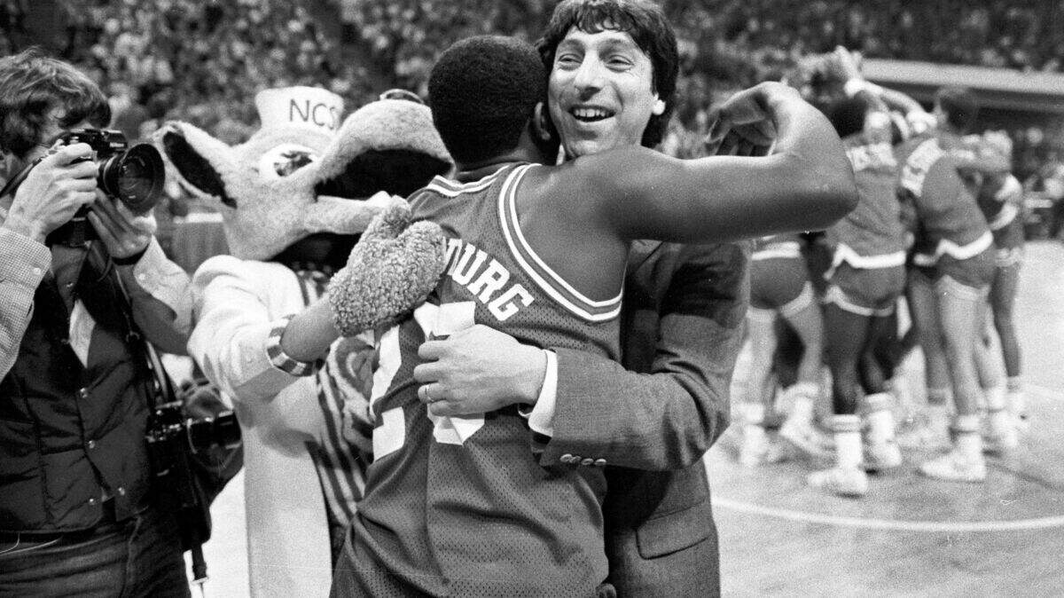 NC State head coach Jim Valvano embraces Dereck Wittenburg as the Wolfpack celebrates their 1983 ACC Tournament championship.