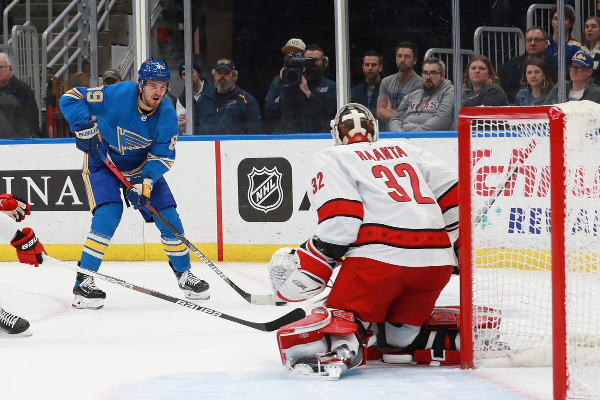 St. Louis Blues’ Pavel Buchnevich (89) shoots against Carolina Hurricanes’ Antti Raanta (32) during the second period of an NHL hockey game Saturday, March 26, 2022, in St. Louis. (AP Photo/Michael Thomas)