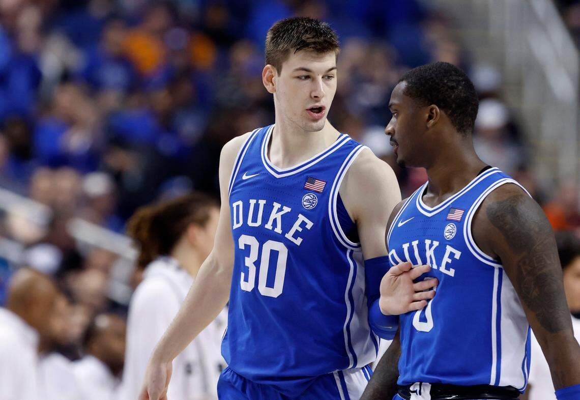 Duke’s Kyle Filipowski (30) talks with Dariq Whitehead (0) during the second half of Duke’s 85-78 victory over Miami in the semifinals of the ACC Men’s Basketball Tournament in Greensboro, N.C., Friday, March 10, 2023.